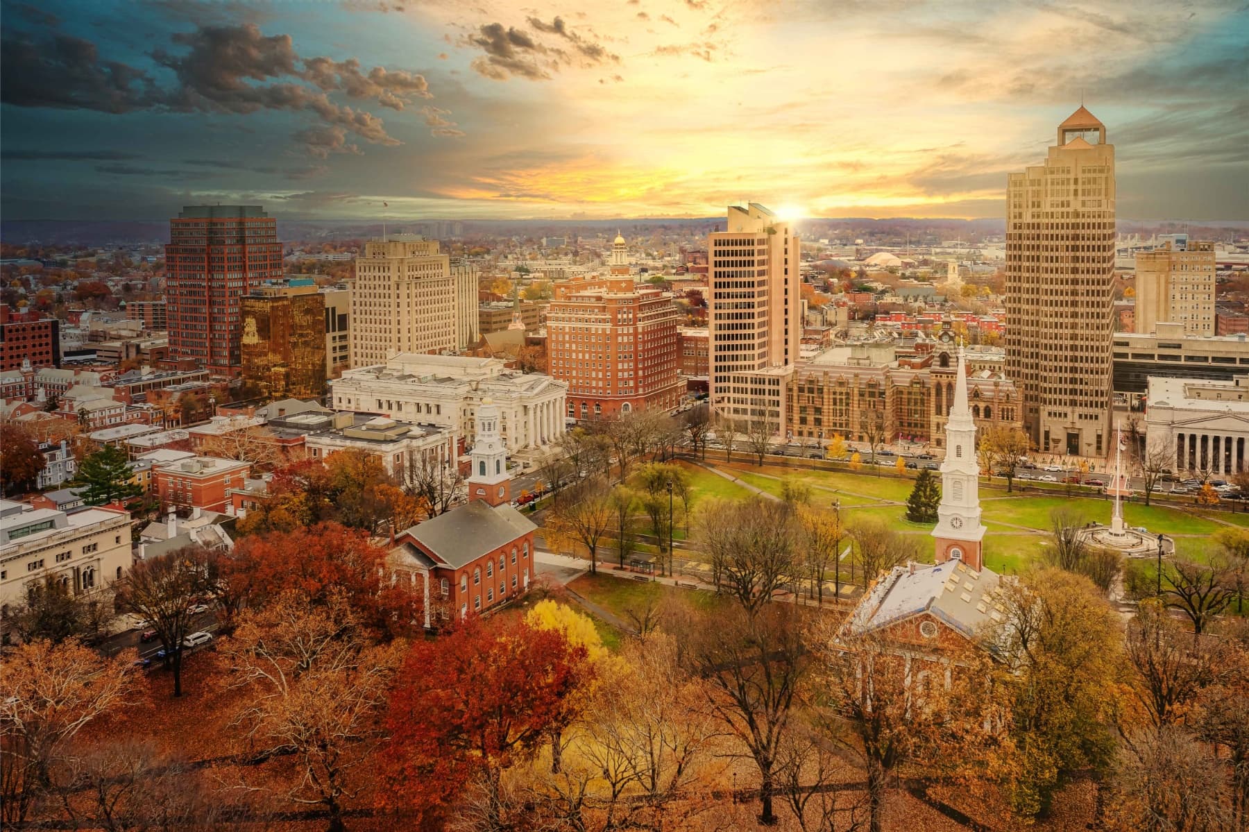 A tall white lighthouse on a rocky shoreline